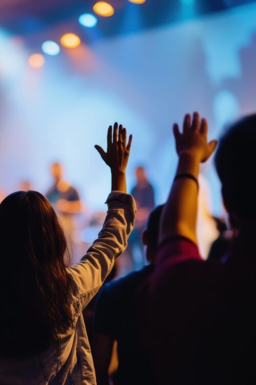 Hands In The Air, People Who Are Praising God And Jesus At A Church Service With Worship Band In The Background,